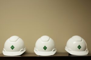 white safety hard hats on shelf