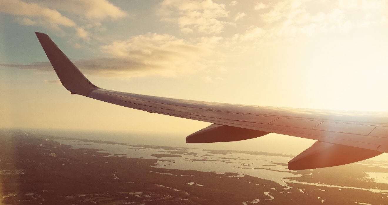 large airliner wing during sunset